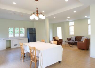 Spacious living and dining area with modern lighting and furnishings