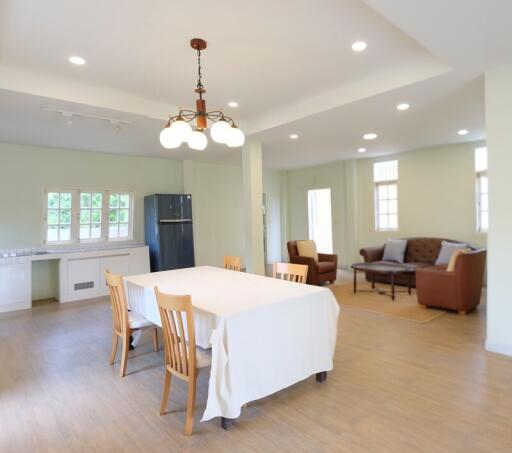 Spacious living and dining area with modern lighting and furnishings