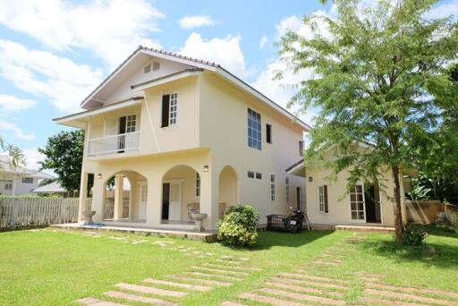 Exterior view of a two-story house with a yard