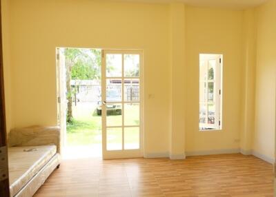 Bright living room with large windows and wooden flooring