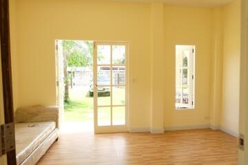 Bright living room with large windows and wooden flooring