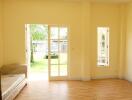 Bright living room with large windows and wooden flooring