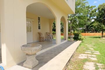 Front porch with seating area and surrounding garden