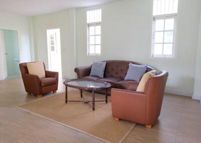 well-furnished living room with sofa and armchairs