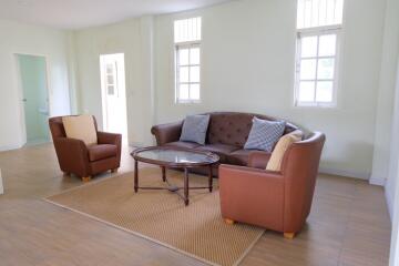 well-furnished living room with sofa and armchairs