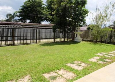 Backyard garden with a lawn and trees