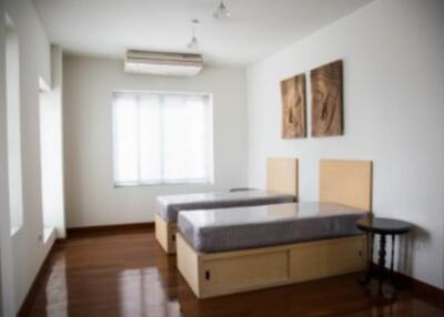 Bedroom with twin beds and wooden floor