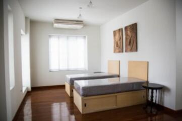 Bedroom with twin beds and wooden floor