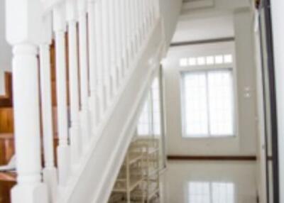 A staircase with wooden steps and white balustrades