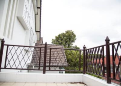 Balcony with railing and view of neighboring houses