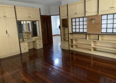 Spacious bedroom with wooden floors and built-in wardrobes