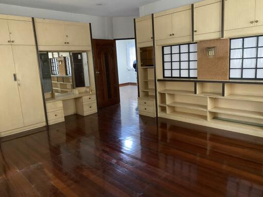 Spacious bedroom with wooden floors and built-in wardrobes