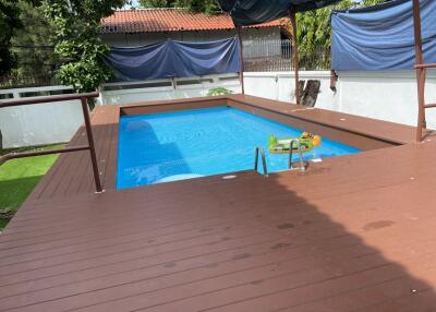 Outdoor swimming pool with deck and shade