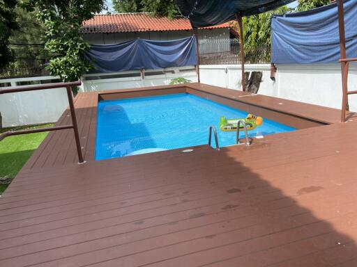 Outdoor swimming pool with deck and shade