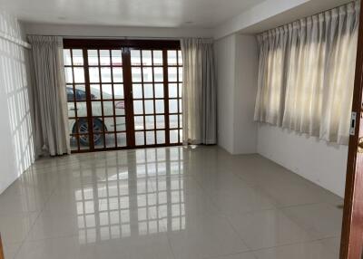 Spacious living room with large windows and curtain