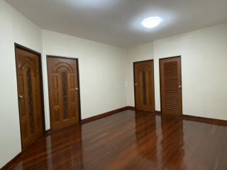 Spacious bedroom with wooden flooring