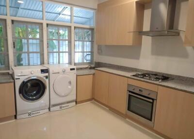 Modern kitchen with appliances and laundry area