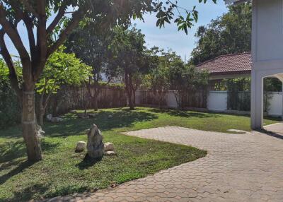 Spacious garden with trees and a pathway