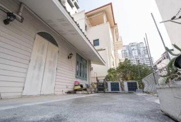 Exterior view of the property with terrace and adjacent buildings