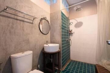 Modern bathroom with toilet, sink, and shower