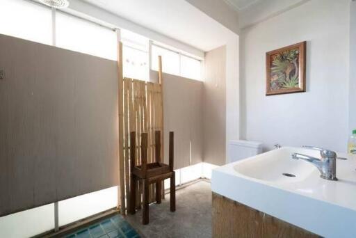 Modern bathroom with natural lighting and wooden accents.