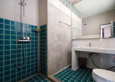 Modern bathroom with shower, sink, and toilet