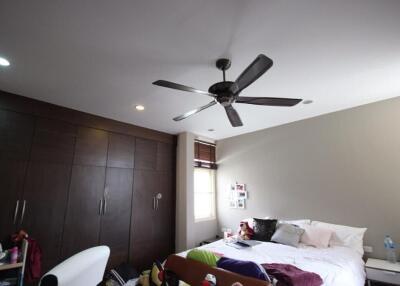 Spacious bedroom with ceiling fan and built-in wardrobe