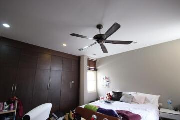 Spacious bedroom with ceiling fan and built-in wardrobe