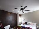 Spacious bedroom with ceiling fan and built-in wardrobe