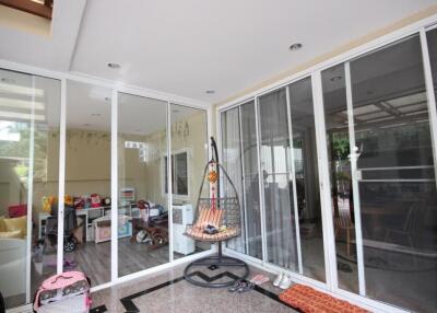 Spacious patio with sliding glass doors and a hanging chair