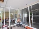 Spacious patio with sliding glass doors and a hanging chair