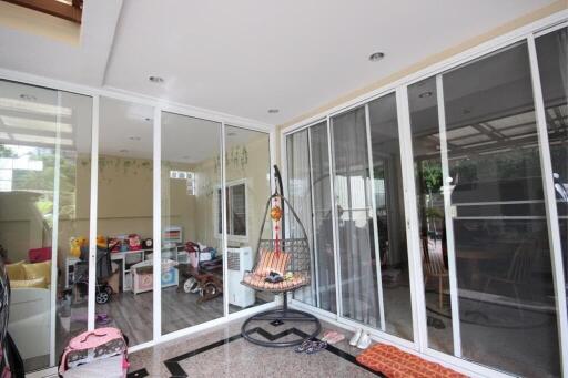 Spacious patio with sliding glass doors and a hanging chair