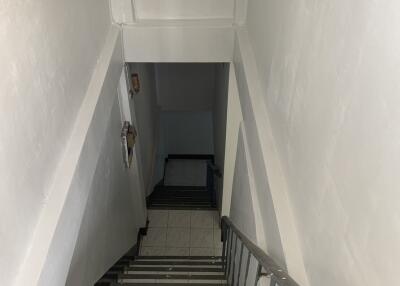 Stairwell with white walls and tiled steps