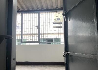 Empty room with tiled flooring and a large window