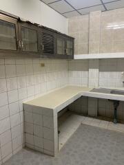 Kitchen with tiled walls and countertops