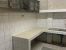 Kitchen with tiled walls and countertops