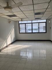 Spacious empty room with tiled floor and large windows