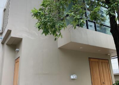 Exterior view of a modern house with large windows and wooden doors