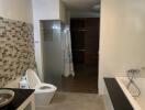 Modern bathroom with tile backsplash, glass shower, and bathtub