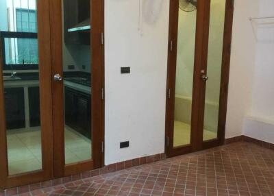 Kitchen area with wooden doors and tile flooring