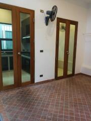 Kitchen area with wooden doors and tile flooring