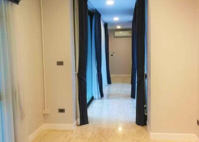 Bright hallway with marble floor and blue curtains