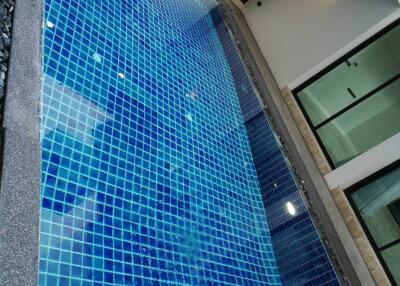 View of a modern swimming pool with blue tiles