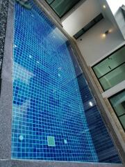 View of a modern swimming pool with blue tiles