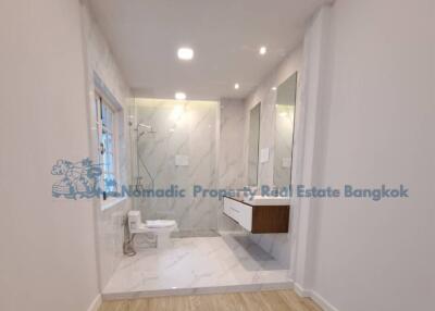 Modern bathroom with shower and large mirror