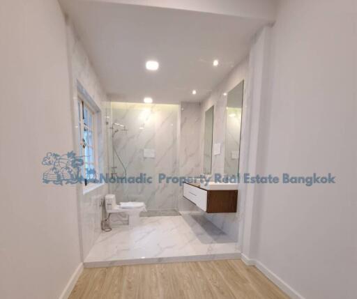 Modern bathroom with shower and large mirror