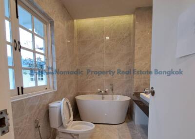 Modern bathroom with freestanding bathtub and window