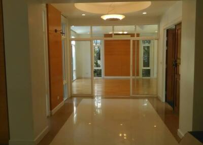 Spacious entryway with sliding doors and modern light fixture