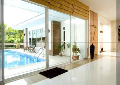 Indoor area with a view of a swimming pool