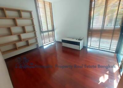 Bedroom with wooden floors and large windows